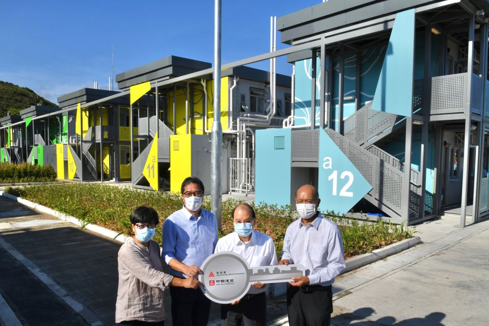 The Chief Secretary for Administration, Mr CHEUNG Kin-chung, Matthew, inspected the quarantine facilities at Penny's Bay on 13 July. Picture shows Mr CHEUNG (second right), accompanied by the Secretary for Development, Mr Michael WONG (second left), and the Director of Architectural Services, Mrs Sylvia LAM (first left), receiving the completed quarantine units from a representative of the contractor at a ceremony.