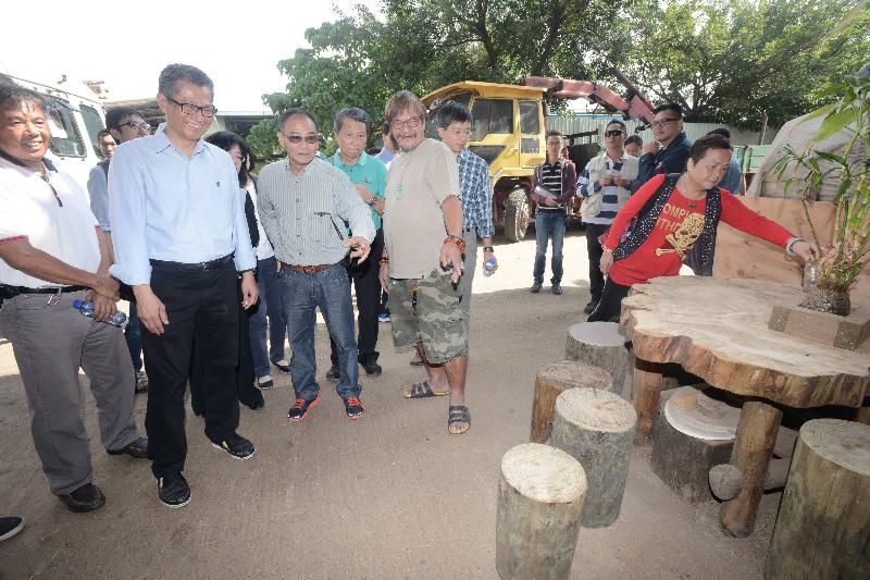 Mr Chan (second left) visits a sawmill in Ma Tso Lung..