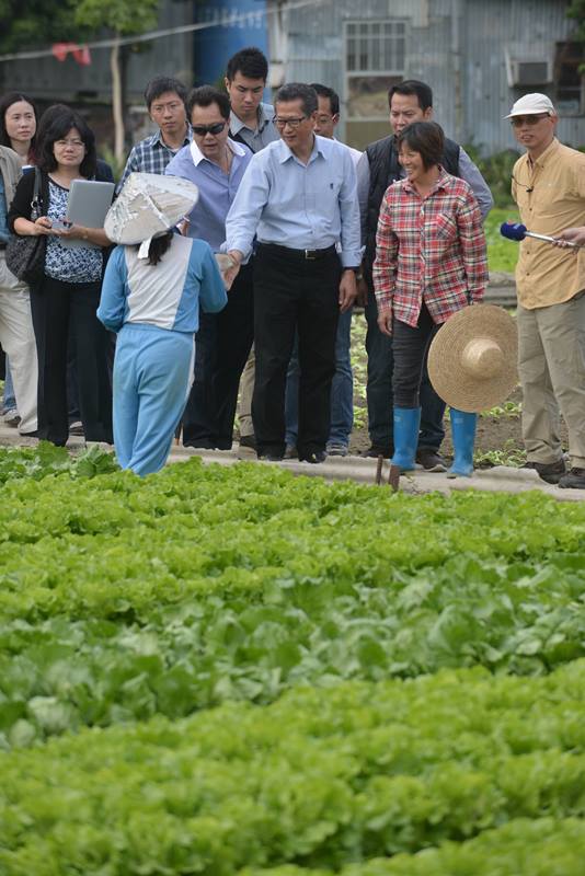 Mr Chan (third right) pays a visit to the farmers in the Long Valley wetland..