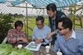 A farmer explains to Mr Chan (second left) the features of organic farming.
