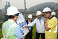 The Secretary for Development, Mr Paul Chan (first right), inspected the underground stormwater storage tank and related facilities at the Happy Valley Underground Stormwater Storage Scheme of the Drainage Services Department (DSD) today (August 1). Picture shows Mr Chan being briefed by the Director of Drainage Services, Mr Edwin Tong (second right) on the DSD's flood prevention measures in response to the threat of Typhoon Nida to Hong Kong.