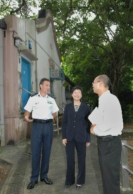 Police District Commander of Tai Po, Mr Charles Mitchell (left), briefs the Secretary for Development, Mrs Carrie Lam, today (September 10) on the history of the old Tai Po Station. On the right is District Officer of Tai Po, Mr Poon Tai-ping.