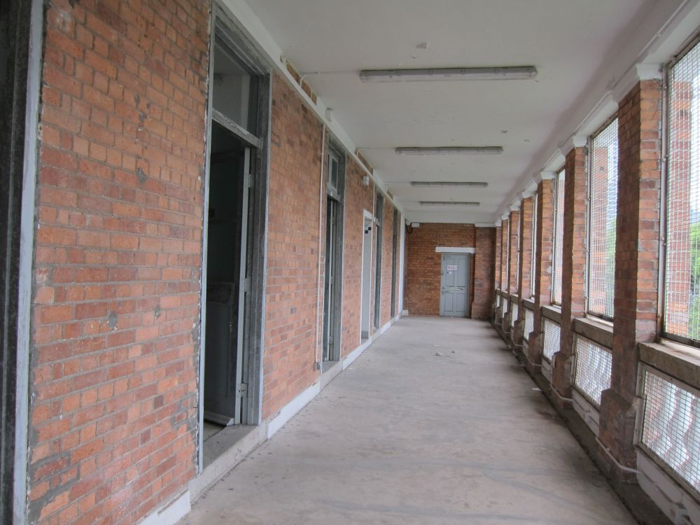 Leading from the main entrance to the building is an open verandah built of red bricks overlooking the Victoria Harbour.