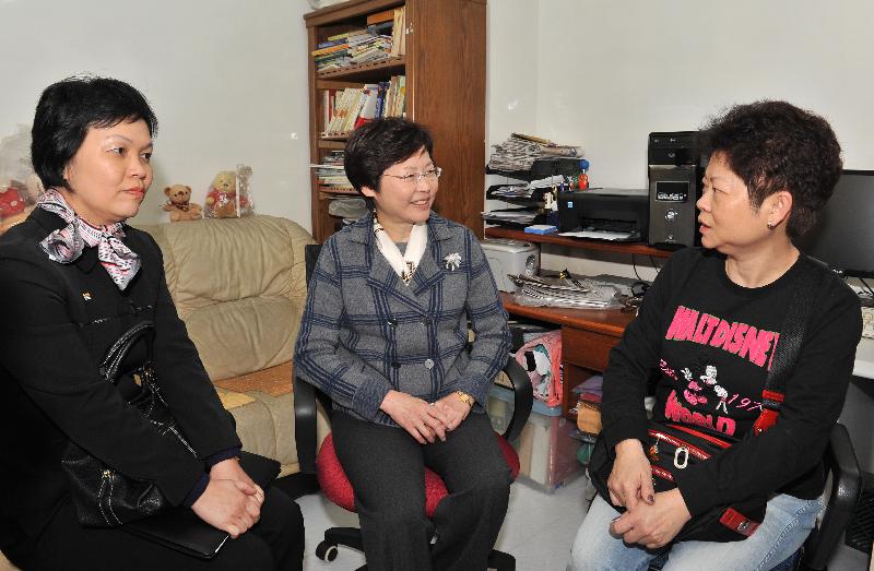 Mrs Lam (centre) meets an owner at the Bank Building in Kwai Chung to listen to her views and experiences regarding the renovation work under Operation Building Bright.