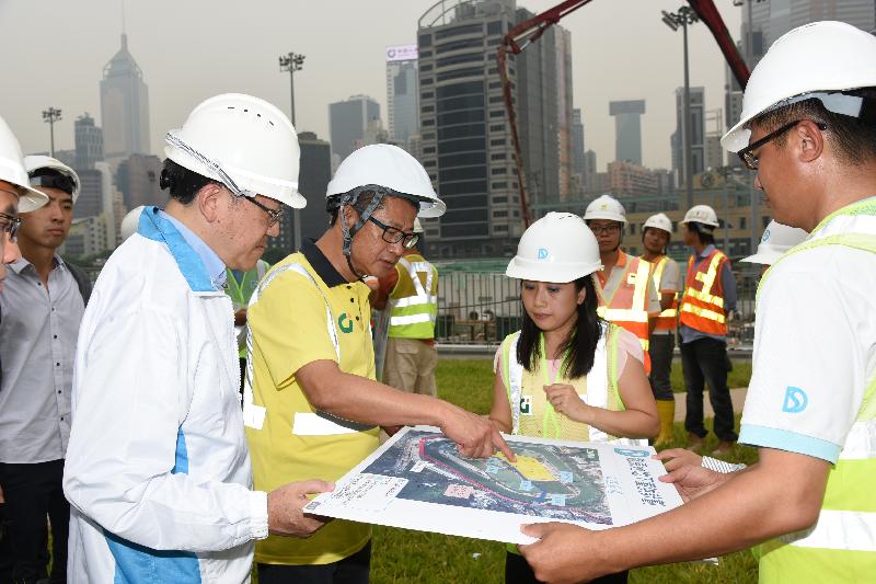 The Secretary for Development, Mr Paul Chan (second left), learns about the progress of the Happy Valley Underground Stormwater Storage Scheme from the Director of Drainage Services, Mr Edwin Tong (first left), and Senior Engineer (Drainage Projects), Ms Ellen Cheng (second right).