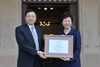 The Secretary for Development, Mrs Carrie Lam (right), presents a certificate of appreciation to the Secretary of Guangzhou University Committee of the Communist Party of China, Mr Yi Zuoyong (left).
