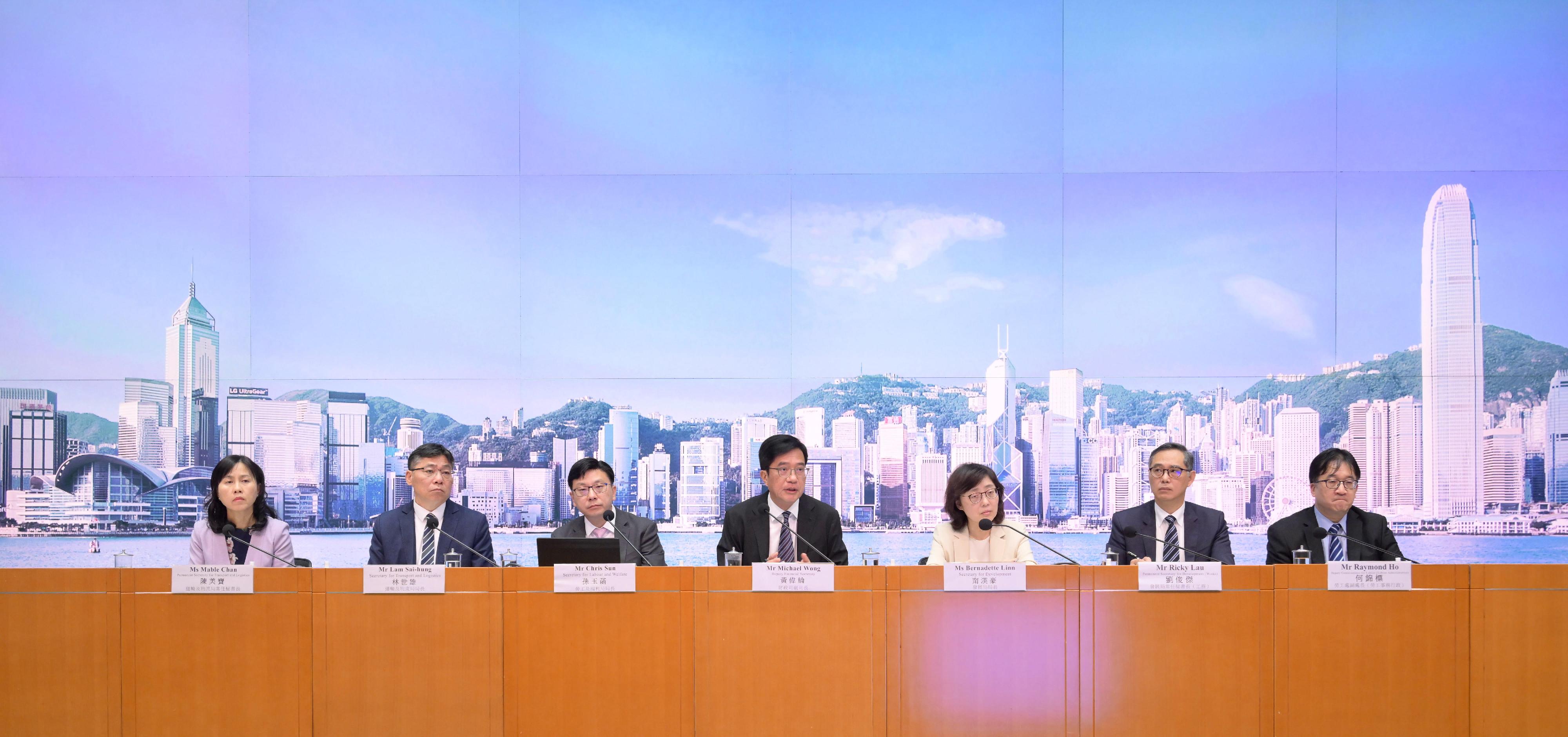 The Deputy Financial Secretary, Mr Michael Wong (centre), holds a press conference on the Government's measures on importation of labour with the Secretary for Transport and Logistics, Mr Lam Sai-hung (second left); the Secretary for Development, Ms Bernadette Linn (third right); the Secretary for Labour and Welfare, Mr Chris Sun (third left); the Permanent Secretary for Transport and Logistics, Ms Mable Chan (first left); the Permanent Secretary for Development (Works), Mr Ricky Lau (second right); and the Deputy Commissioner for Labour (Labour Administration), Mr Raymond Ho (first right), at the Central Government Offices, Tamar, this afternoon (June 13).