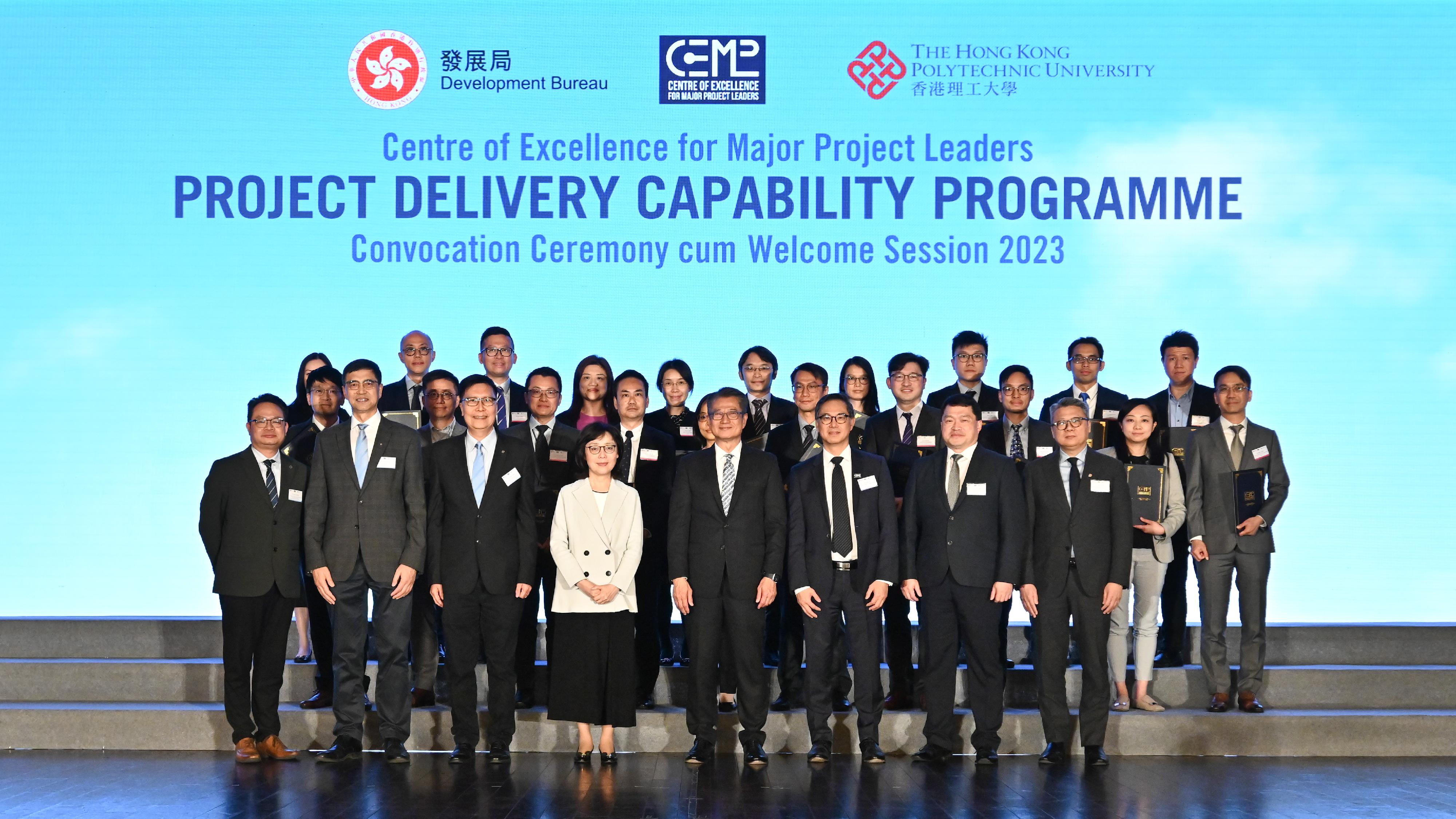 The Centre of Excellence for Major Project Leaders (CoE) under the Development Bureau held the Convocation Ceremony cum Welcome Session 2023 of its Project Delivery Capability Programme today (March 6). Photo shows the Financial Secretary and Honorary President of the CoE, Mr Paul Chan (first row, fourth right); the Secretary for Development and Chairman of the CoE, Ms Bernadette Linn (first row, fourth left); the Permanent Secretary for Development (Works) and Superintendent of the CoE, Mr Ricky Lau (first row, third right), the Dean of Students and Chair Professor of Construction Engineering and Management of the Hong Kong Polytechnic University, Professor Albert Chan (first row, third left); and the Head of Project Strategy and Governance Office of the Development Bureau, Mr John Kwong (first row, second right), with other guests and graduates at the ceremony.