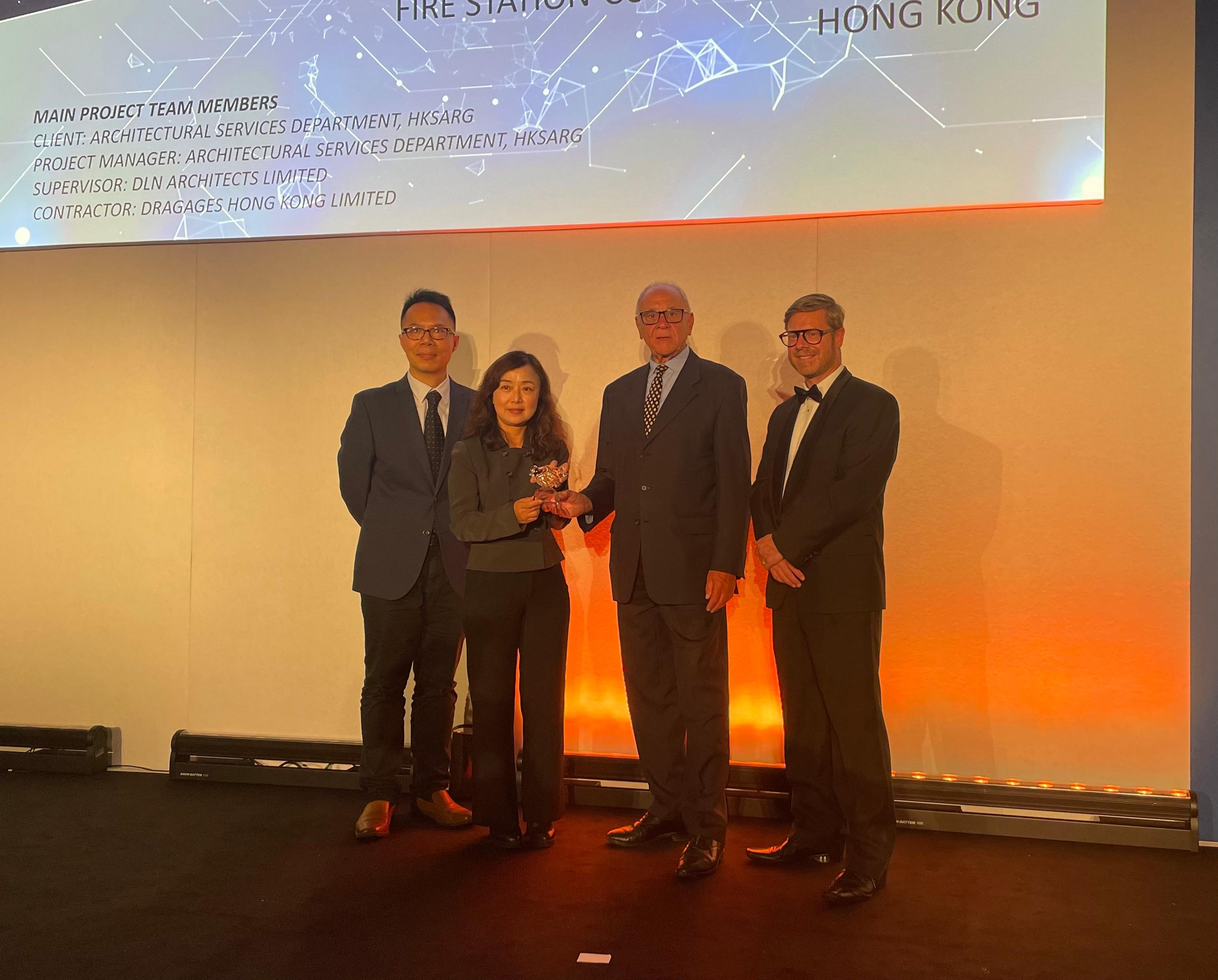 The Development Bureau and its works departments achieved encouraging results with multiple awards and commendations at the New Engineering Contract Annual Conference 2023 and Prize Presentation Ceremony of the Martin Barnes Awards 2023 in London, the United Kingdom today (July 13, London time). Photo shows the Project Director of Architectural Services, Ms Athena Fung (second left), receiving the Building/Facility Management Project of the Year and Sustainability Award of the Year awards on behalf of the Architectural Services Department at the ceremony.