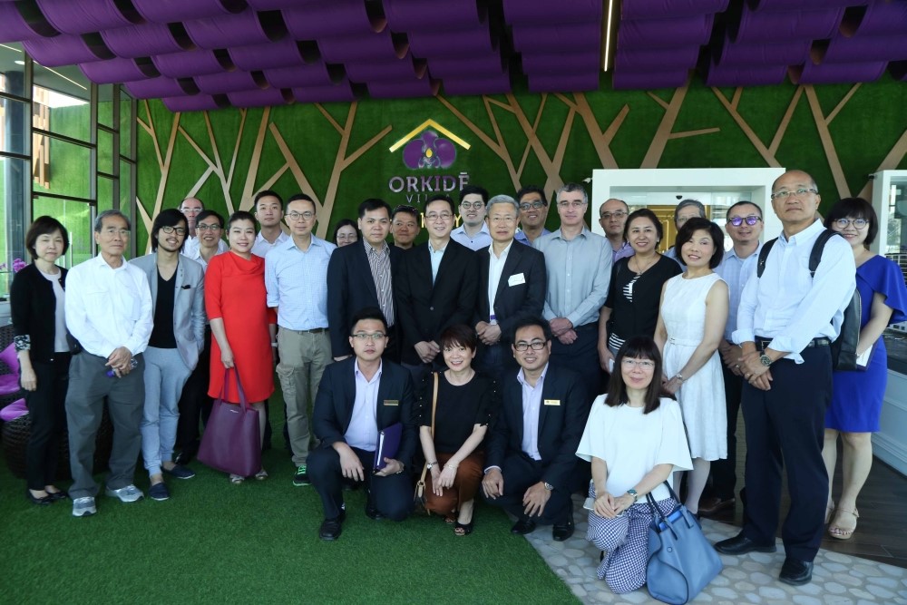 Group photo shows the delegation with the staff of a property development project after a visit.