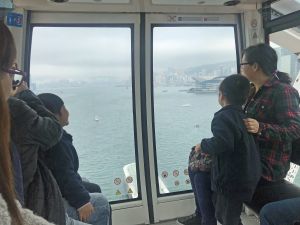 Mr Michael WONG, SDEV, introduces to the kindergarten children buildings on both sides of Victoria Harbour.