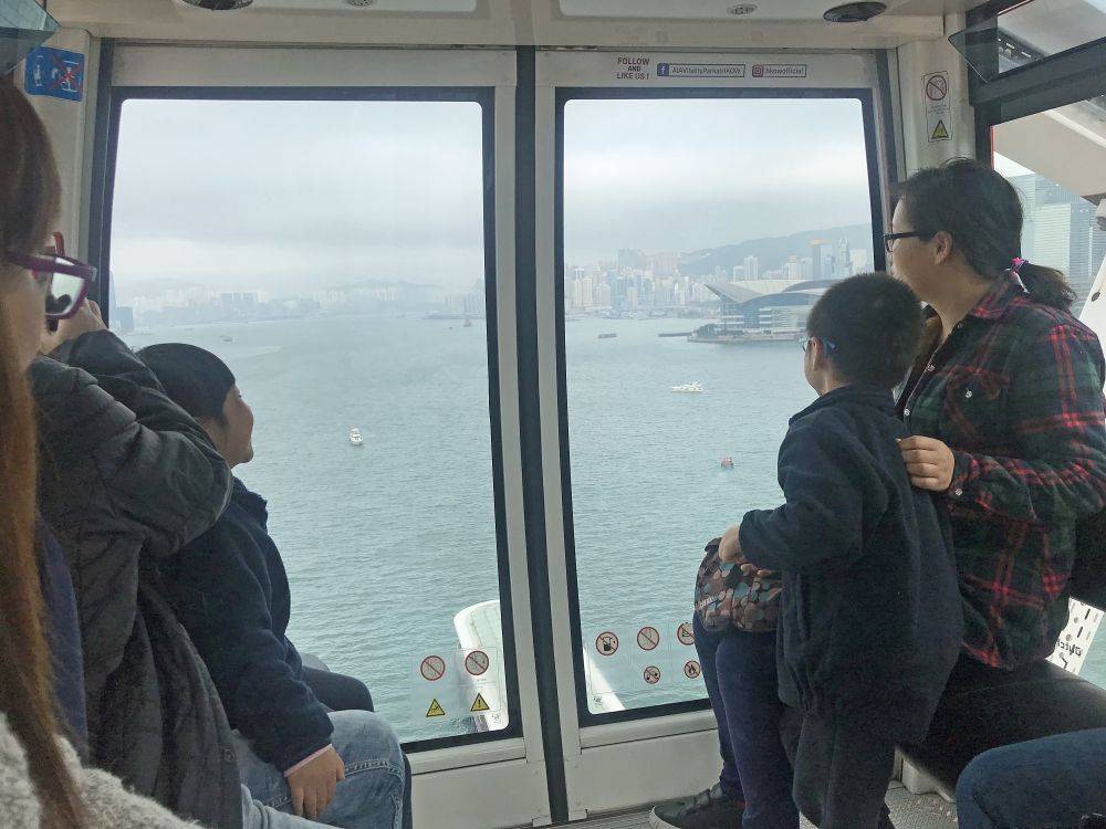 Mr Michael WONG, SDEV, introduces to the kindergarten children buildings on both sides of Victoria Harbour.