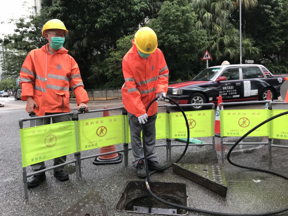According to Mr KOO (left), upon arriving at the scene, the DSD’s frontline workers will use devices to test for any poisonous or explosive gas in manholes, and they will only open them if the results are normal.  After that, they will desilt the blocked drains with rattan strips or high-pressure water jets.