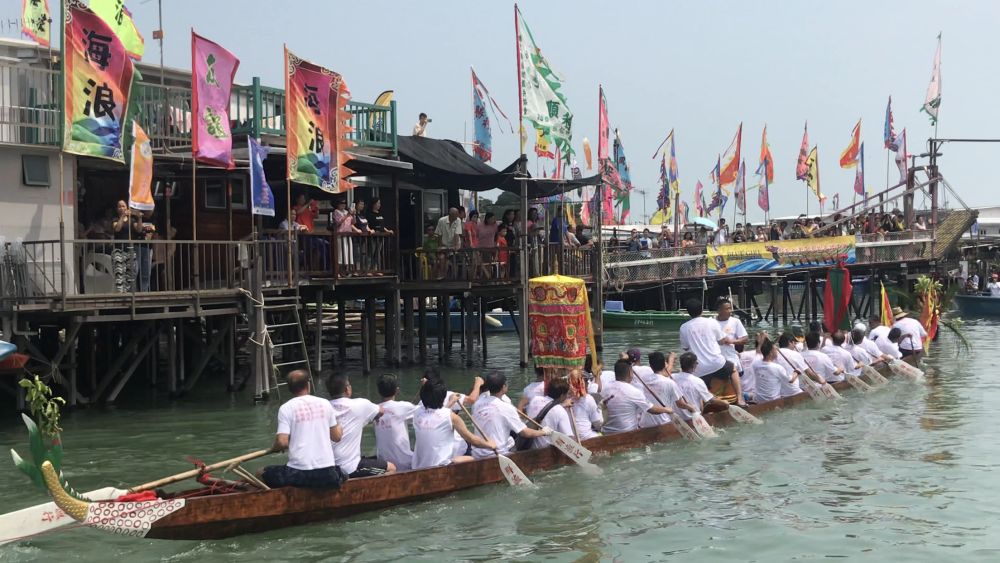 During the parade ritual, dragon boats tow deity statues on sacred sampans to parade through the watercourses between stilted houses in Tai O.