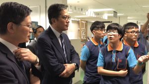 More than 200 trainees are recruited annually under the EMSD’s Technician Training Scheme, including quite a number of female trainees interested in the electrical and mechanical industry.  Pictured is a female trainee showing various training equipment items to the SDEV, Mr Michael WONG.