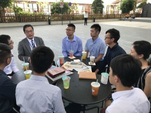 The Secretary for Development (SDEV), Mr WONG Wai-lun, Michael, chats with several young Geotechnical Engineering Graduates (GEGs) and Engineering Geology Graduates (EGGs) of the Geotechnical Engineering Office (GEO) to learn about their training and work experiences under the training schemes. (Pictured here is the meeting place under the flyover at the Kwun Tong Promenade.)