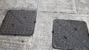The grid patterns, or raised studs, on the manhole covers not only enhance skid resistance, but also allow drainage workers to identify two kinds of manhole covers.