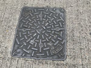 The round and radical pattern indicates a drainage manhole cover.