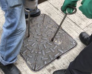 The two round keyholes, shaped like eyes, allow workers to pull up the cover with special tools.