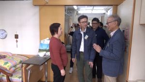 The Executive Director of the Neighbourhood Advice-Action Council, Mr TAI Keen-man (first right), and the Superintendent of the Shanghai Fraternity Association Care & Attention for the Elderly, Ms LI Yuk-yin (first left), introduce the facilities of the home to the USDEV, Mr LIU Chun-san (second left).