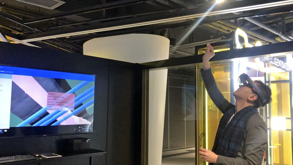 Wearing a pair of HoloLens that looks like goggles, the PA, Mr Allen FUNG looks at construction facilities or parts and sees relevant simulated images and information on the physical objects.  Even the direction of the water flow in the pipes can be shown.
