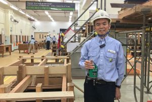 The Supervising Instructor, Mr. CHAU Kam-po, uses an infrared level instrument to demonstrate how to assess the works of the candidates.