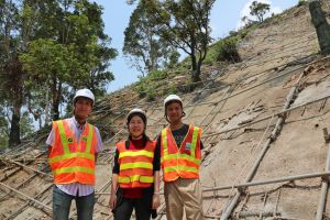Ms TING (centre) and her colleagues have to work under the scourging sun or in the rain from time to time.