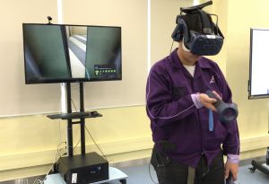 A trainee demonstrates how he uses VR technology to learn how to repair lifts.