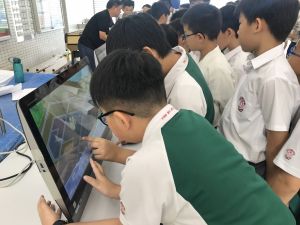 Students getting to know about the town planning process with the aid of exhibition panels and a computer simulation software.