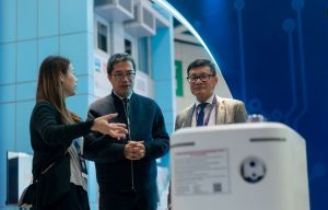 The SDEV, Mr Michael WONG (centre), is accompanied by the Executive Director of the CIC, Mr Albert CHENG (right), to visit several exhibition booths at the CIExpo.
