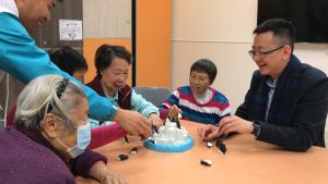 The PA, Mr Allen Fung (first right), plays games with the elderly.