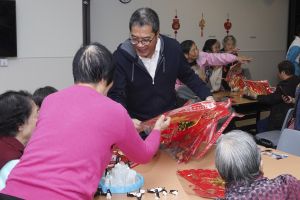 Distributing spring couplets of the Year of the Rat to the elders.