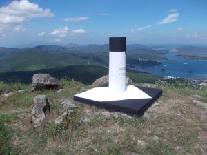 A triangulation station, which is usually erected at a mountain peak. The white shaft and the black top facilitate observation from a distance.