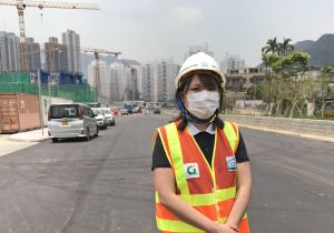 Engineer of the Civil Engineering and Development Department (CEDD), Ms WAY Yuet-wah, who is standing at the project location of the formation, roads and drains in Area 54, Tuen Mun, explains how the Works Group of Departments and the contractor have minimised the impact of the epidemic on the works progress through project management and rearrangement of work procedures.