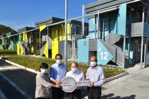 The Chief Secretary for Administration, Mr CHEUNG Kin-chung, Matthew, inspected the quarantine facilities at Penny's Bay on 13 July. Picture shows Mr CHEUNG (second right), accompanied by the Secretary for Development, Mr Michael WONG (second left), and the Director of Architectural Services, Mrs Sylvia LAM (first left), receiving the completed quarantine units from a representative of the contractor at a ceremony.