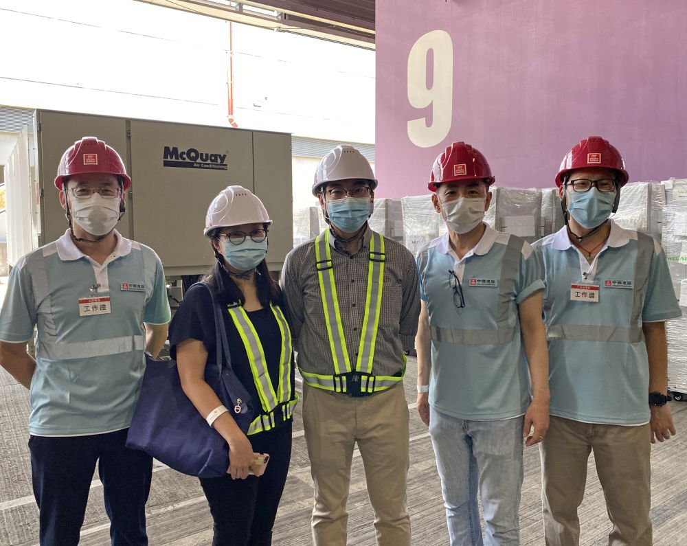 Chief Building Services Engineer of the Architectural Services Department, Mr CHAN Ming-yee (centre) says that eight chillers and about 120 Mobile Modular High Efficiency Particulate Air Filtering Units will be installed to ensure that the exhibition halls will be suitable for use as a community treatment facility. Mr CHAN Ming-yee is pictured with his colleague and the contractor’s staff.