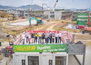 The most memorable work experience of Ms Iris LAU (fifth right) is her participation in the design and construction of quarantine camps last year. 