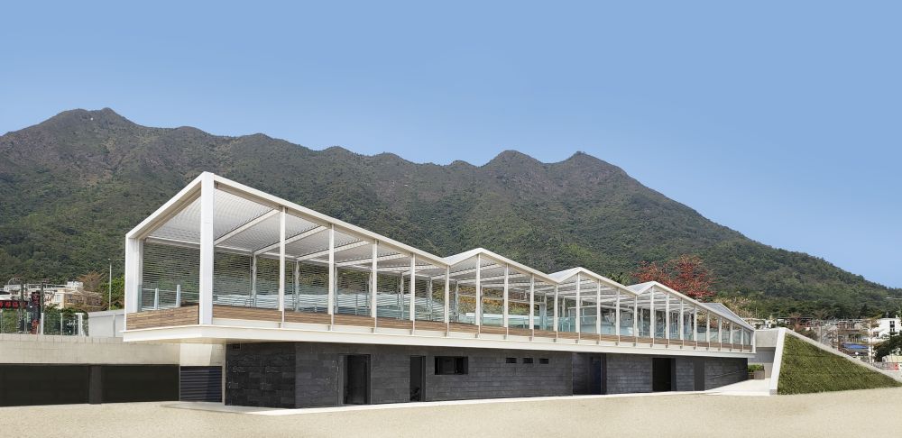 The rippling roof of the observation deck echoes the ridgeline of Pat Sin Leng in the background.