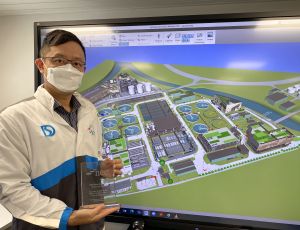 Mr CHUNG Ching-hong, Romeo, Senior Engineer/Sewerage Projects of the DSD, holds on his hand the Water Project of the Year award for the Expansion of Shek Wu Hui Sewage Treatment Works.