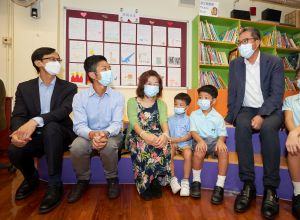 The SDEV, Mr Michael WONG (first from the right), is chatting with students and parents. The first from the left is the C for H, Mr Ivanhoe CHANG.