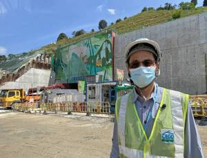Senior Explosives Officer of the GEO, Mr NG Siu-ming, says that blasting is necessary for many works projects in Hong Kong. An example is the relocation of Sha Tin Sewage Treatment Works to caverns in Nui Po Shan of A Kung Kok behind him.