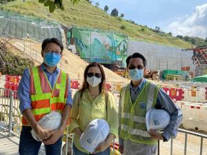 Toiling silently over the years, colleagues of the Mines Division work to enhance public safety and contribute to the development of Hong Kong's infrastructure through responsible regulation. Picture shows (from left) Senior Geotechnical Engineer of the GEO, Mr HUNG Kin-chung, Roy; Geotechnical Engineer of the GEO, Ms LAU Nga-yan, Phoebe and Senior Explosives Officer of the GEO, Mr NG Siu-ming taking a group photo in front of the caverns in Nui Po Shan of A Kung Kok.