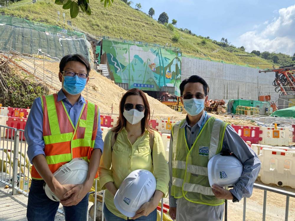 Toiling silently over the years, colleagues of the Mines Division work to enhance public safety and contribute to the development of Hong Kong's infrastructure through responsible regulation. Picture shows (from left) Senior Geotechnical Engineer of the GEO, Mr HUNG Kin-chung, Roy; Geotechnical Engineer of the GEO, Ms LAU Nga-yan, Phoebe and Senior Explosives Officer of the GEO, Mr NG Siu-ming taking a group photo in front of the caverns in Nui Po Shan of A Kung Kok.