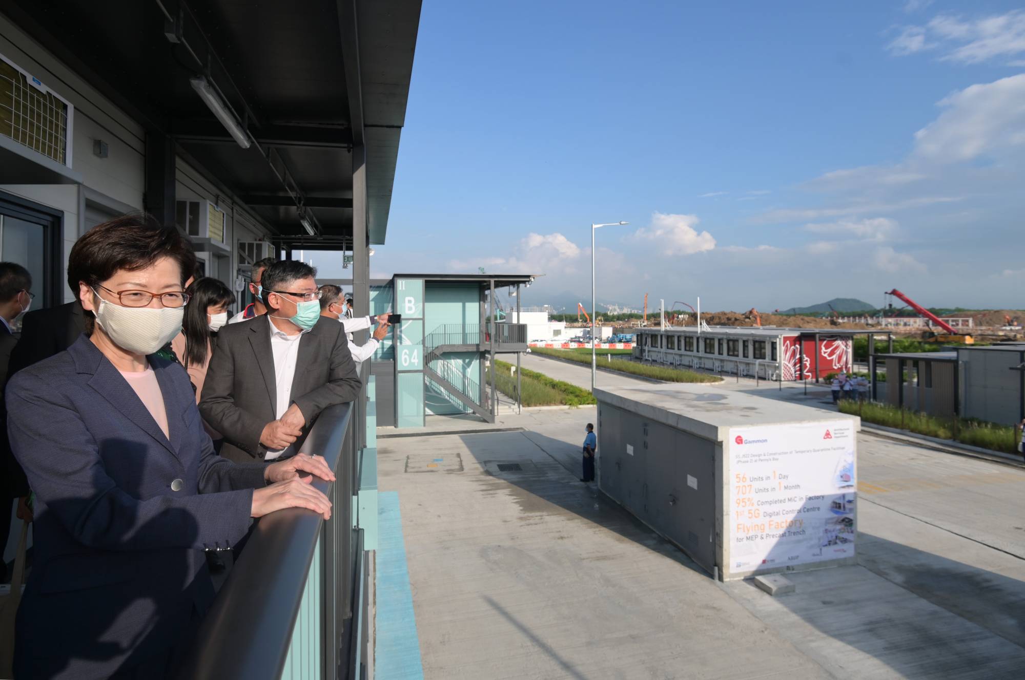 Pictures show the Chief Executive, Mrs LAM CHENG Yuet-ngor, Carrie (first left), paying a visit to the construction site of phase 3 and phase 4 of the quarantine centre, and a quarantine unit in phase 2 of the centre on Lantau Island in September last year. Next to her is Mr LAM Sai-hung.