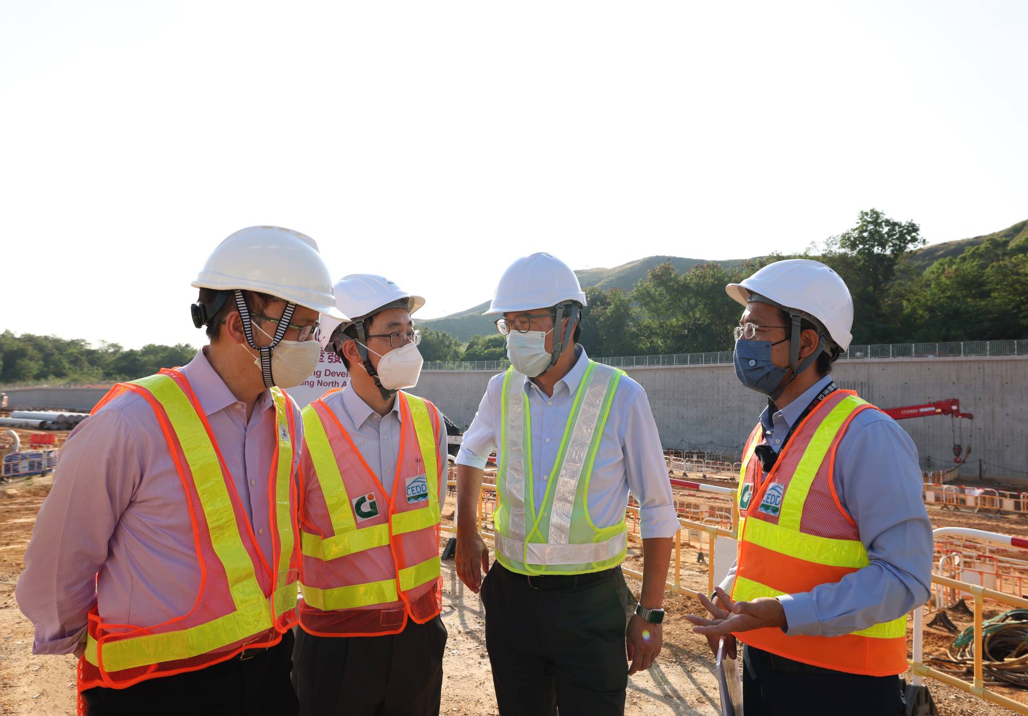 Accompanied by the Project Manager (North) of the North Development Office of the Civil Engineering and Development Department (CEDD), Mr LAI Cheuk-ho (second left), and the Chief Engineer of the North Development Office of the CEDD, Mr CHO Wai-hung, Mike (first right), the Secretary for Development (SDEV), Mr WONG Wai-lun, Michael (second right), and the Under Secretary for Development, Mr LIU Chun-san (first left) inspect the works progress in the Kwu Tung North/Fanling North (KTN/FLN) New Development Area (NDA).