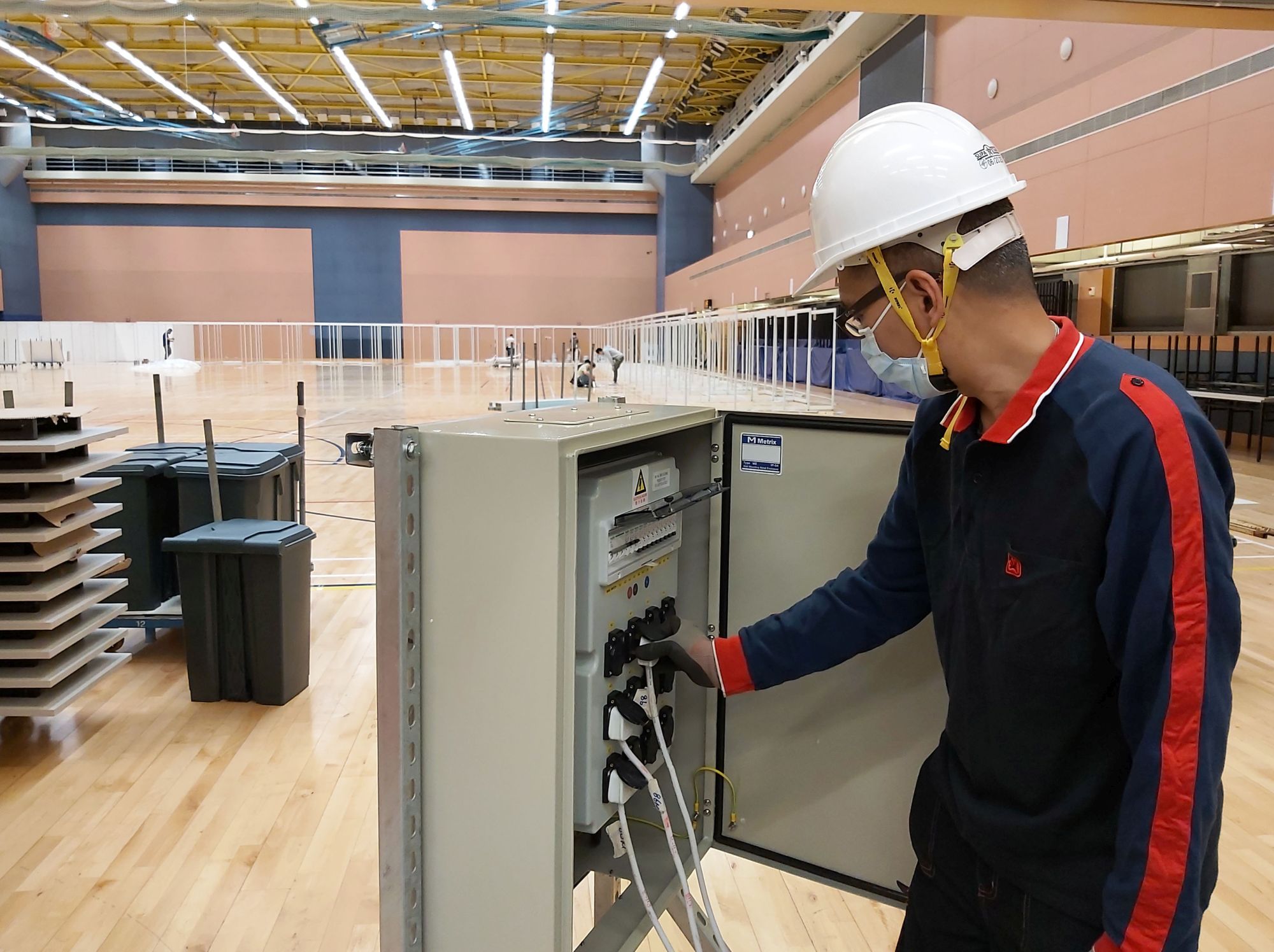 An EMSD’s colleague is carrying out the required alteration works in the Sun Yat Sen Memorial Park Sports Centre for the operation of a community vaccination centre.