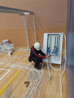 Picture shows an EMSD’s colleague carrying out addition works to the power supply and lighting systems.