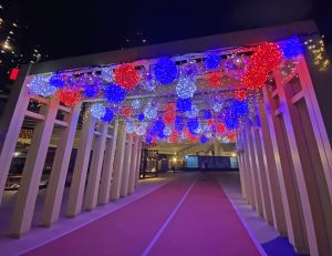 The art installations placed at the East Coast Park Precinct are characterised by local elements, including a neon sign that reads “Victoria Harbour Café” in Chinese characters and light balls made of plastic bags in the iconic red-white-blue colours.