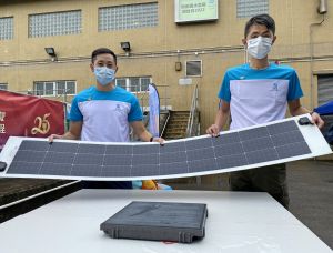 Mr LAI Hong-ho (left) and Mr CHIM Sai-shing (right) introduce the flexible PV system and the steppable PV system, which are installed respectively on the covers of the screw pump channels at the intake of the San Tin Stormwater Pumping Station, and on the walkway of the maintenance platform.