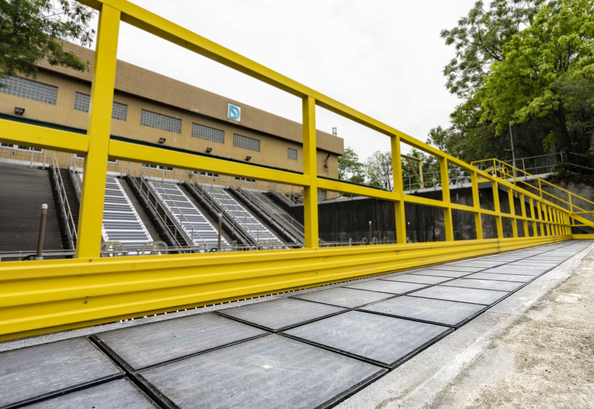 Mr LAI Hong-ho (left) and Mr CHIM Sai-shing (right) introduce the flexible PV system and the steppable PV system, which are installed respectively on the covers of the screw pump channels at the intake of the San Tin Stormwater Pumping Station, and on the walkway of the maintenance platform.